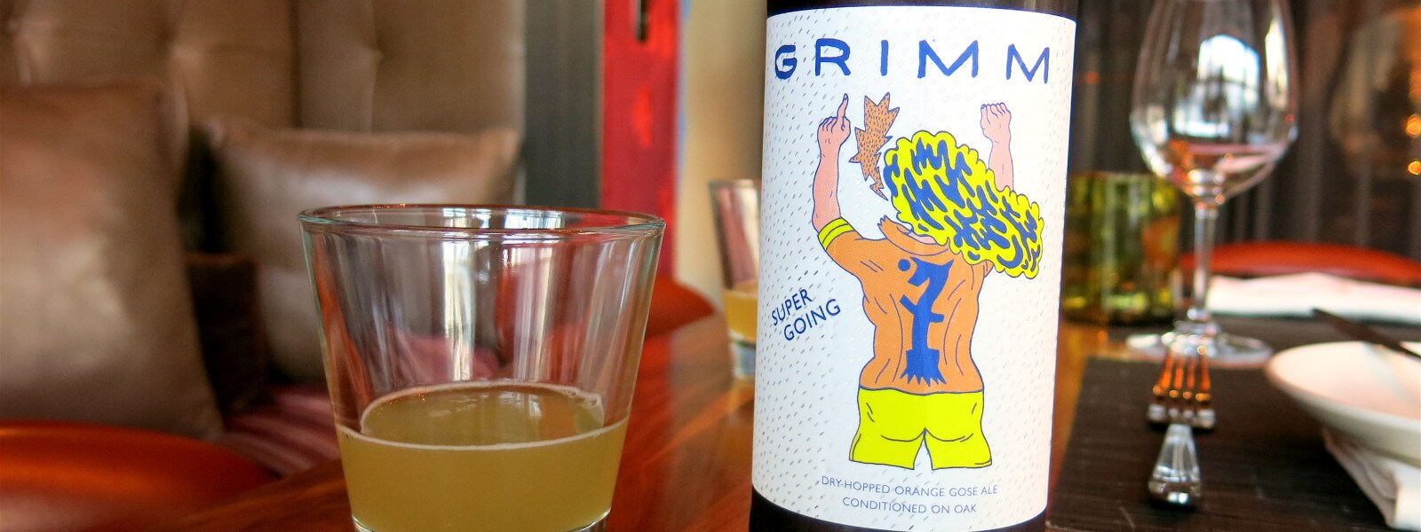 Bottle of Grimm Beer and small glass with beer.