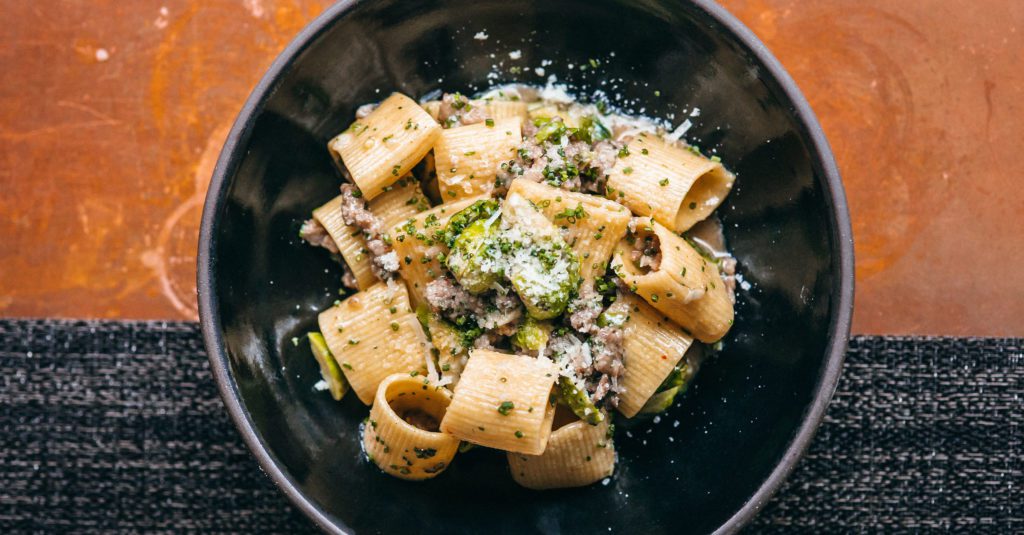Rigatoni dish with fresh grated cheese and chives.