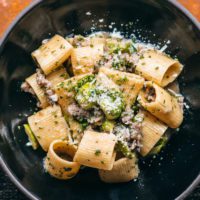 Rigatoni dish with fresh grated cheese and chives.