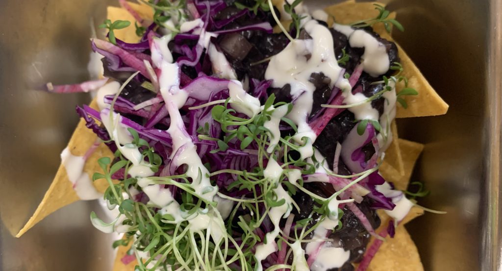 Black bean nachos with red cabbage and fresh queso.